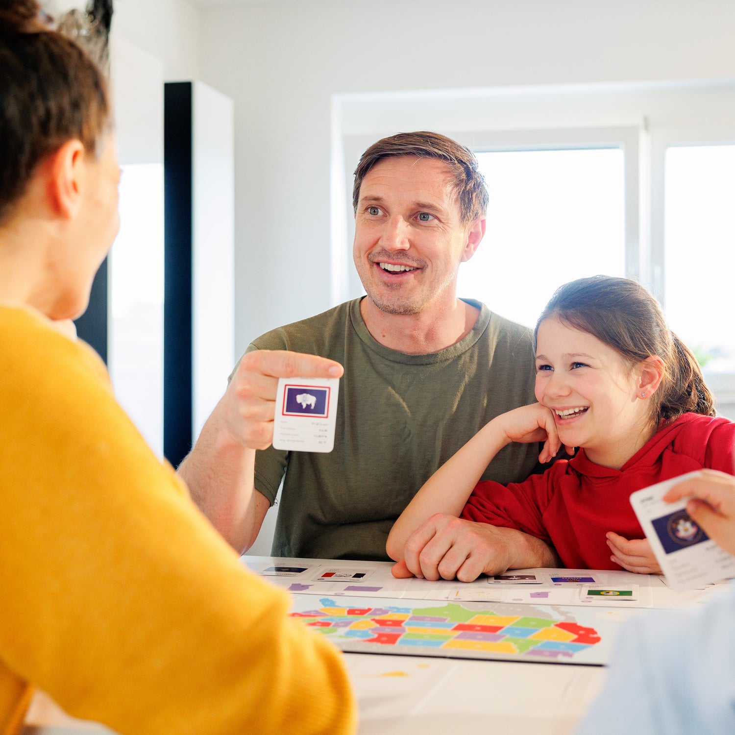 parents homeschooling their kids with the 50 states game board game learning about the geography of the united states of America