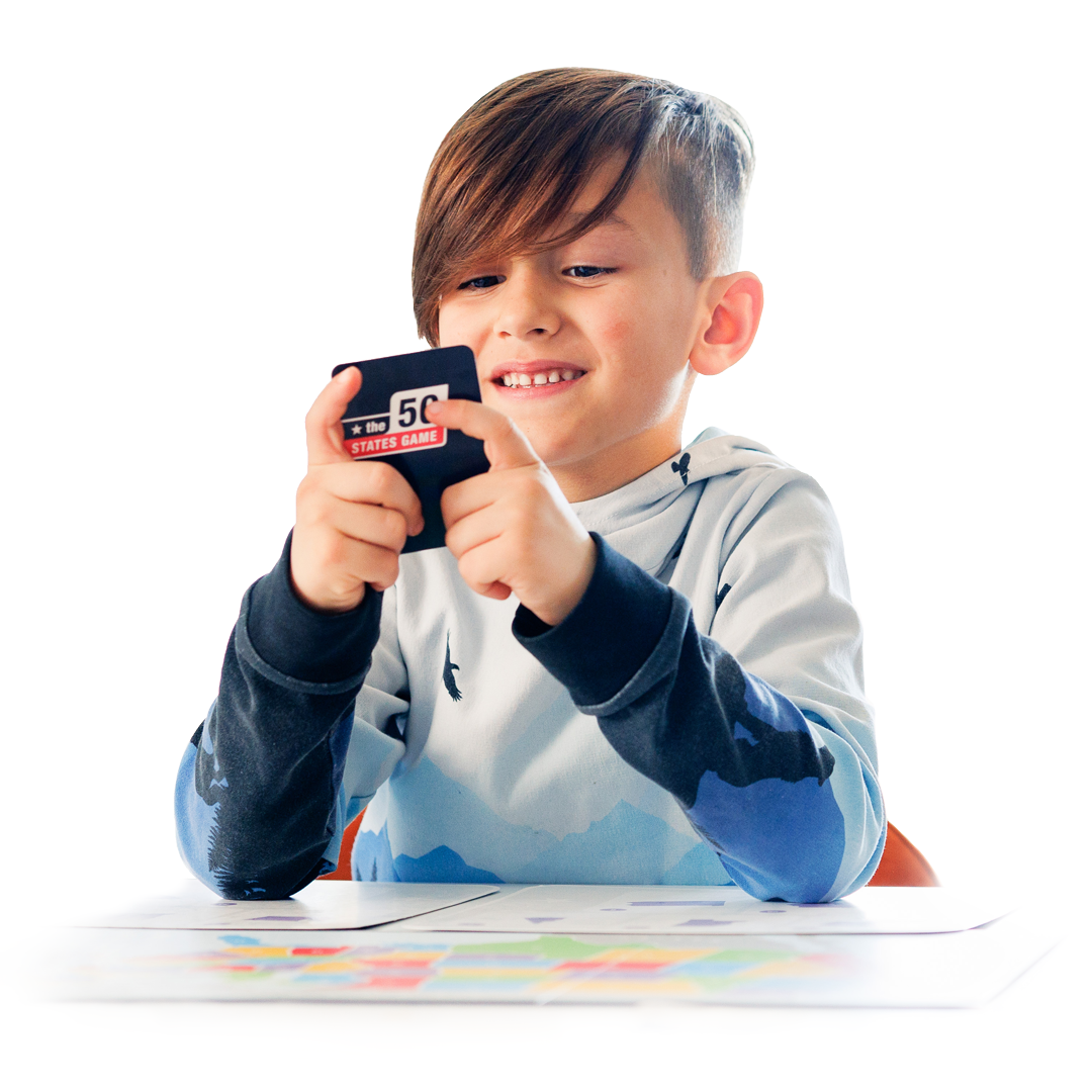 a young boy holding a 50 states game card and playing the 50 states game learning about the united states of America board game
