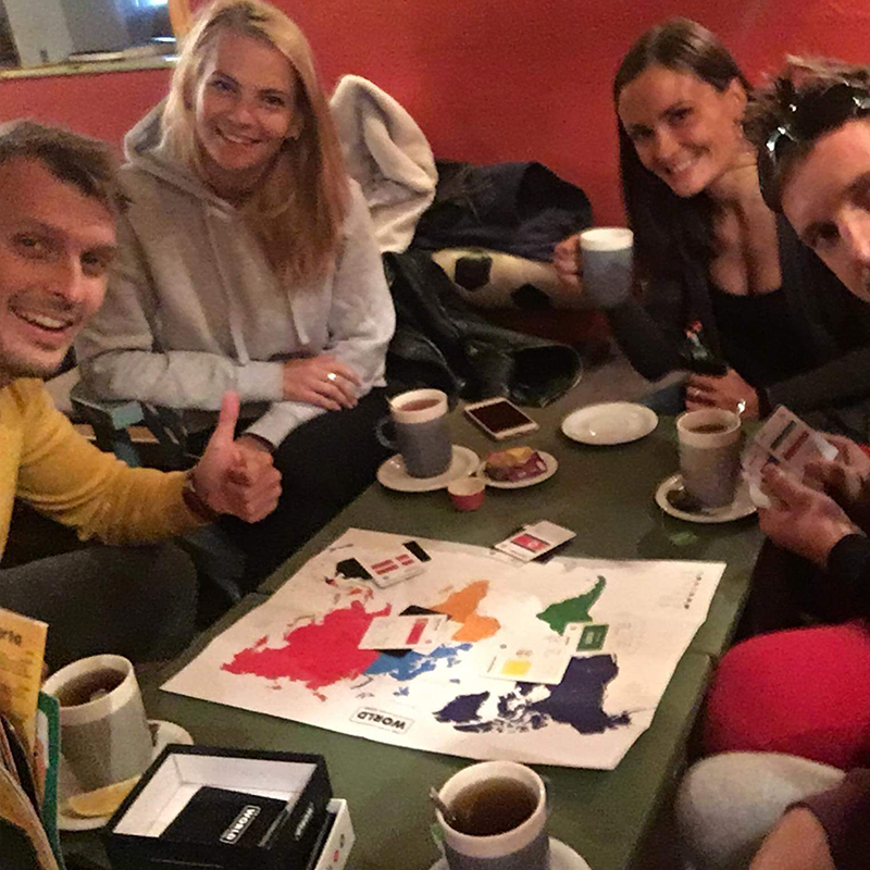 Friends having a game night with the world game learning about countries of the world