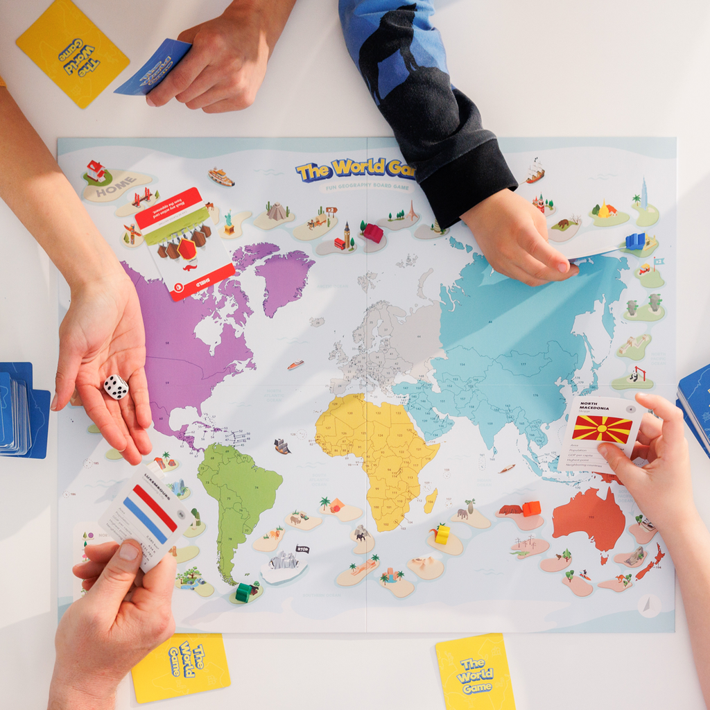 The world game fun geography board game family playing this fun geography game and learning while having fun with maps flags and cards