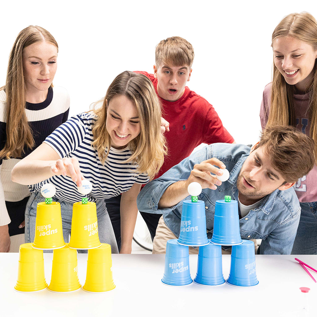 Super Skills action packed game for competitive people by the world game stacking cups and ping pong balls friends having fun